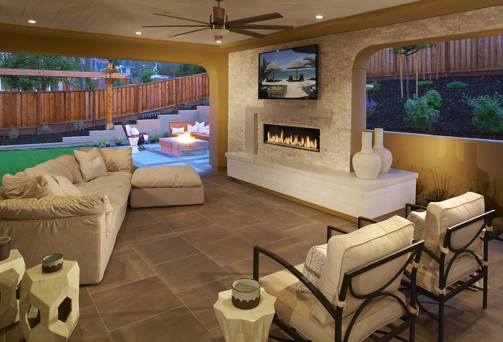 Chic open-concept living space by SummerHill Homes featuring a modern kitchen, cozy lounge area, and elegant pendant lighting.