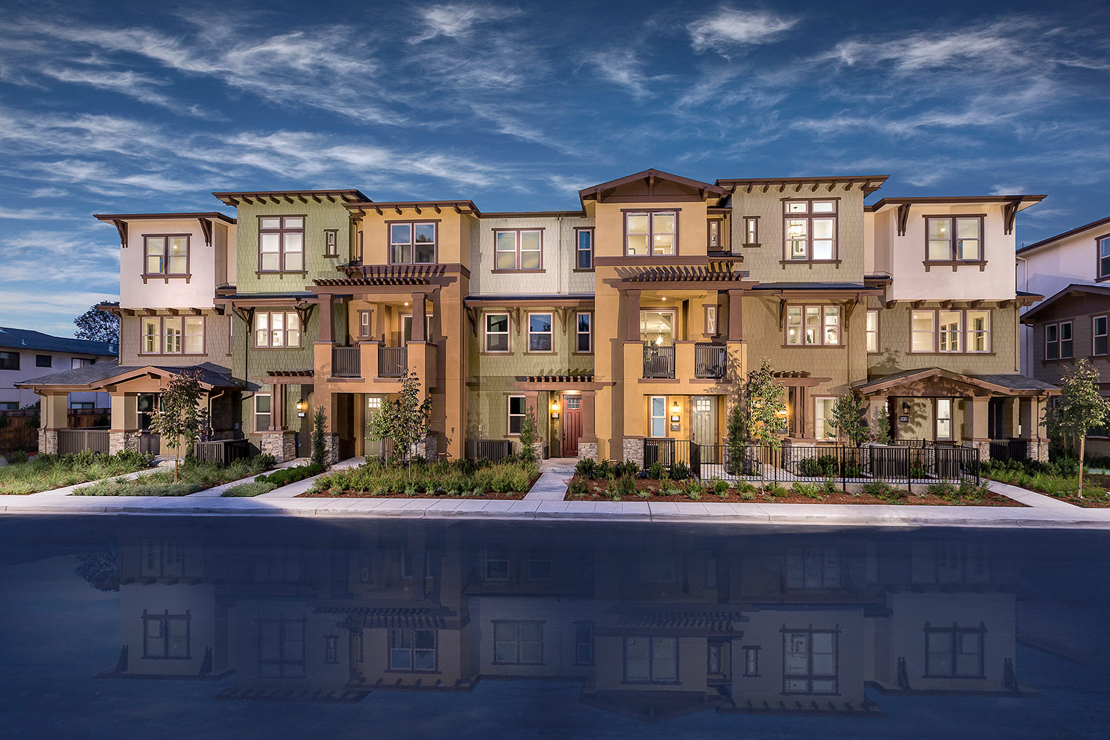 Spacious open-concept kitchen and living area by SummerHill Homes, featuring a large island with seating, modern appliances, and elegant lighting.